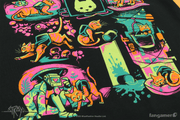 The bottom of the Stray Antics shirt design in a closeup photo. The cat is shown in a collage knocking something over, smiling next to a robot, sleeping on a pillow, running from enemies, and staring out from a bucket.  Thumbnail